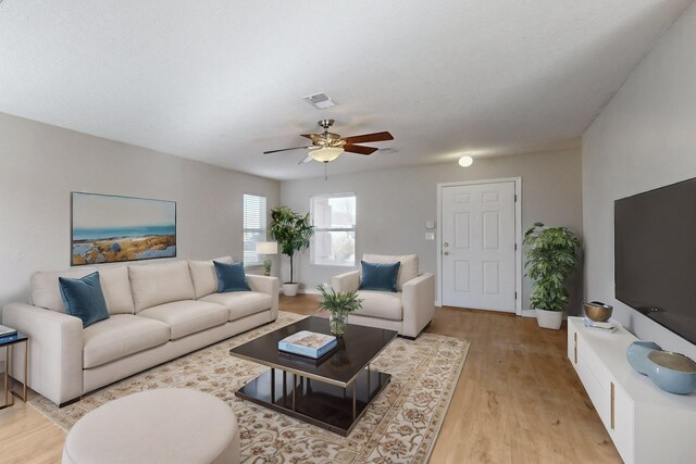 living room featuring ceiling fan and light hardwood / wood-style flooring