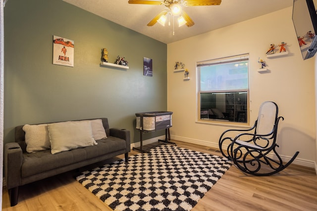 sitting room featuring ceiling fan and light hardwood / wood-style flooring