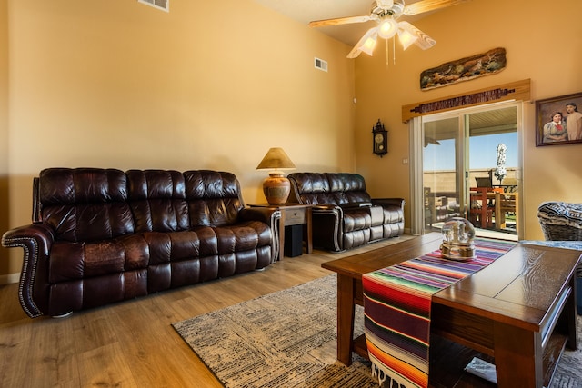 living room featuring ceiling fan and light hardwood / wood-style flooring