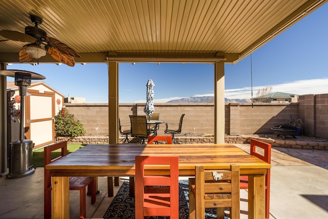 view of patio featuring a mountain view and ceiling fan