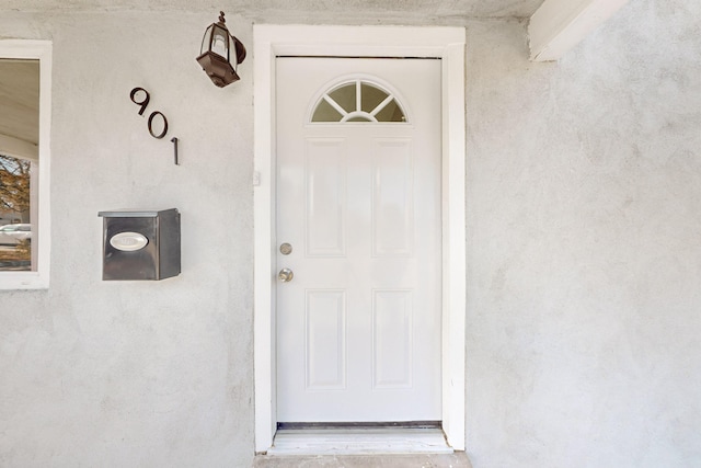 property entrance featuring stucco siding