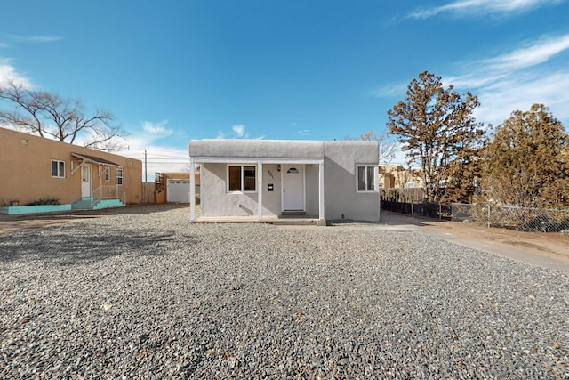 view of front of property with fence and stucco siding