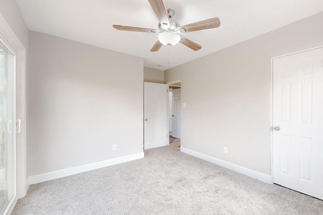 unfurnished bedroom with carpet, baseboards, and a ceiling fan