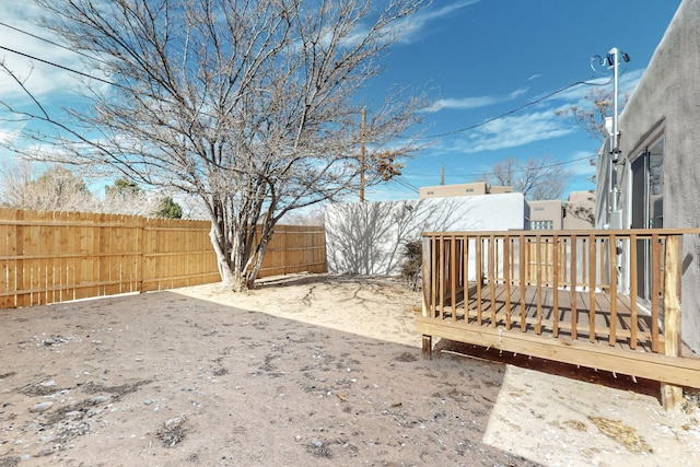 view of yard featuring a fenced backyard and a wooden deck