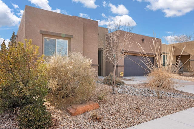 pueblo-style house with a garage