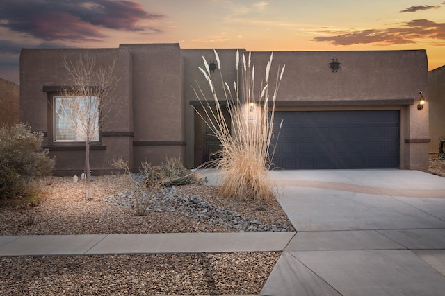 pueblo-style home featuring a garage