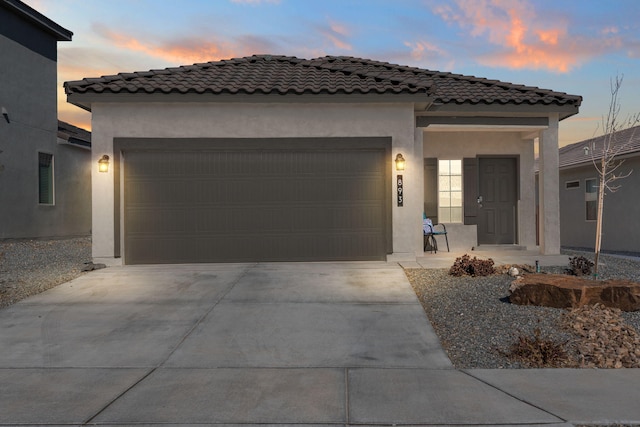 mediterranean / spanish-style home with a garage