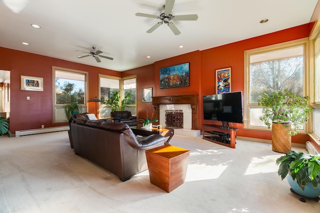 carpeted living room with ceiling fan and a baseboard radiator