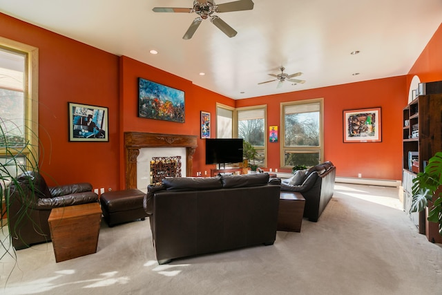 carpeted living room featuring baseboard heating and ceiling fan