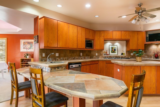 kitchen featuring tasteful backsplash, sink, a breakfast bar area, and appliances with stainless steel finishes