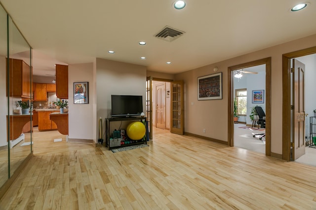 interior space with light hardwood / wood-style floors and ceiling fan