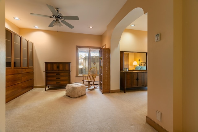 sitting room with light colored carpet and ceiling fan