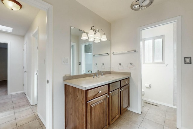 bathroom featuring vanity, tile patterned floors, and toilet