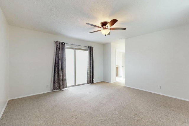 carpeted spare room with ceiling fan and a textured ceiling