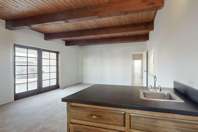 kitchen featuring sink, light carpet, wood ceiling, and french doors