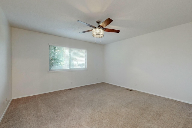 unfurnished room featuring light colored carpet and ceiling fan