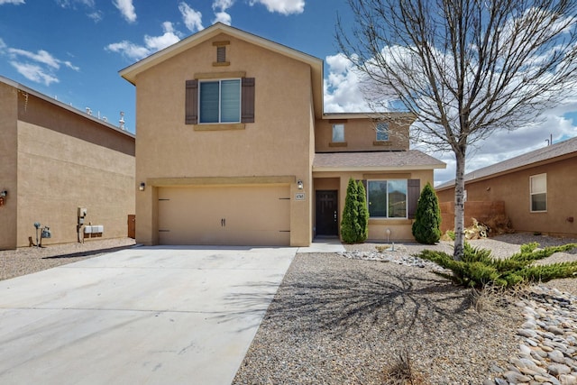 traditional-style home with a garage, driveway, and stucco siding