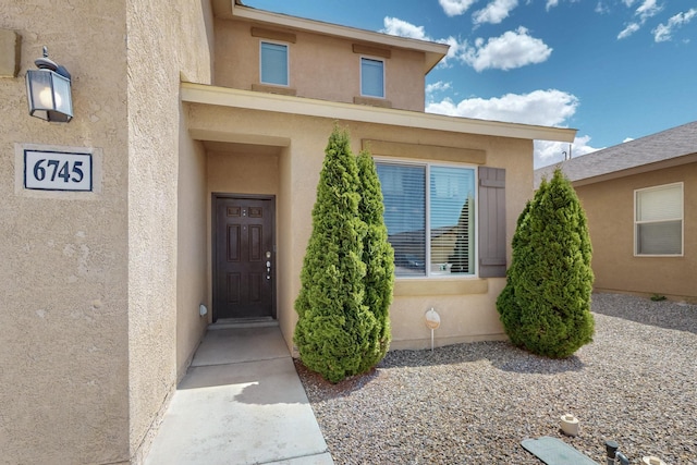 entrance to property with stucco siding