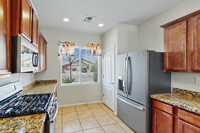 kitchen featuring stainless steel appliances, recessed lighting, stone counters, light tile patterned floors, and visible vents