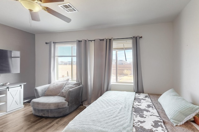 bedroom with ceiling fan and light wood-type flooring