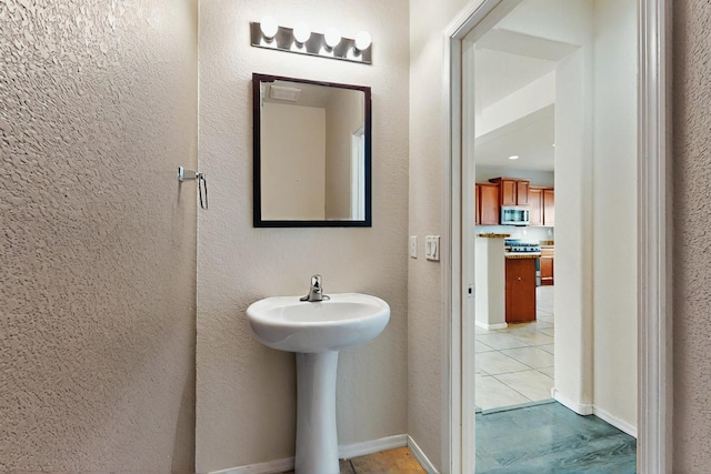 bathroom with tile patterned flooring and a sink