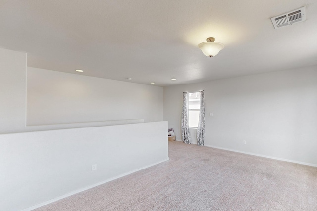 unfurnished room with light colored carpet