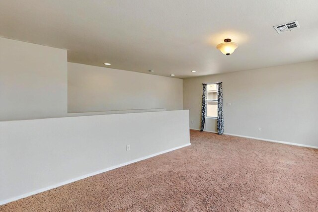 empty room with recessed lighting, baseboards, visible vents, and carpet