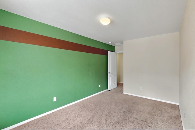 carpeted empty room with baseboards