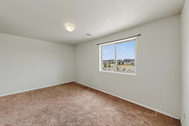 unfurnished room featuring baseboards, carpet flooring, and visible vents