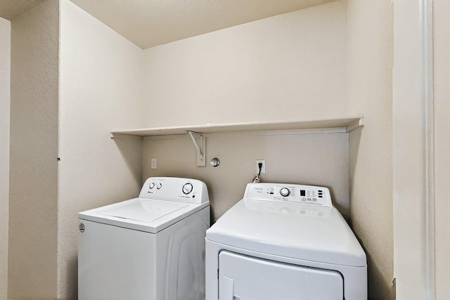 washroom featuring separate washer and dryer and laundry area