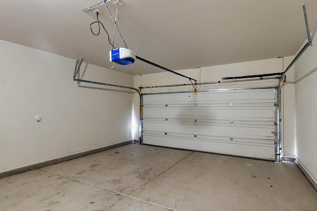 garage featuring baseboards and a garage door opener