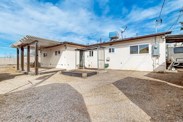 back of property featuring a patio area, fence, and stucco siding