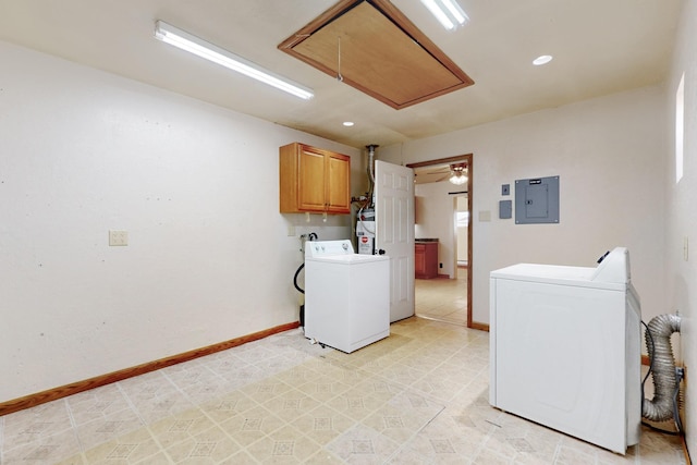 washroom with baseboards, cabinet space, electric panel, washing machine and clothes dryer, and attic access