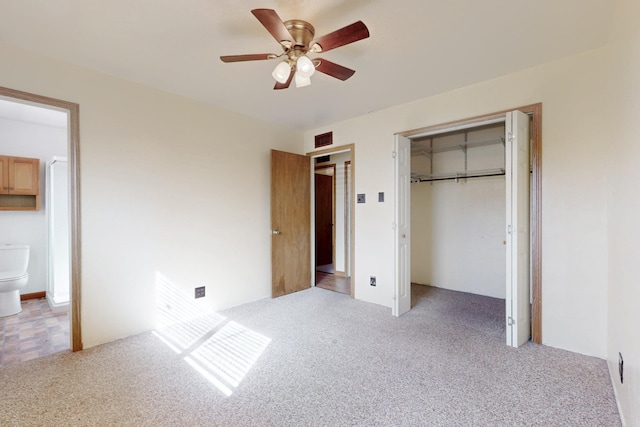 unfurnished bedroom with light carpet, visible vents, a closet, and ensuite bathroom