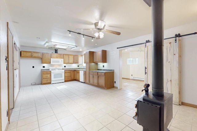 kitchen with a baseboard radiator, light countertops, a ceiling fan, a sink, and white appliances