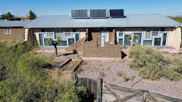 rear view of house with central AC unit