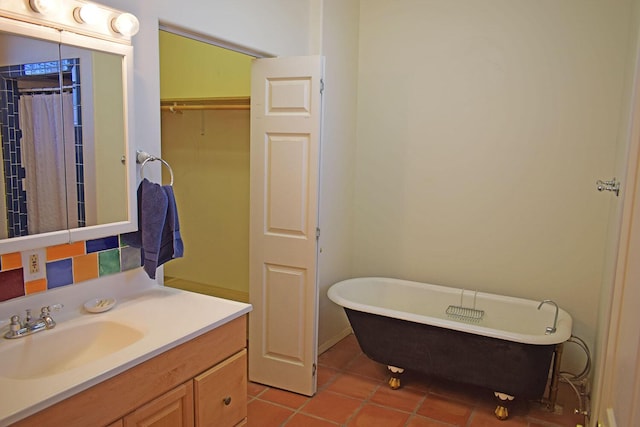 bathroom featuring a bathing tub, tile patterned floors, and vanity