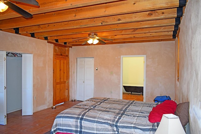 bedroom featuring beamed ceiling, ceiling fan, and tile patterned floors