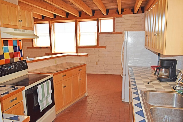 kitchen with sink, beam ceiling, electric range, brick wall, and tile countertops