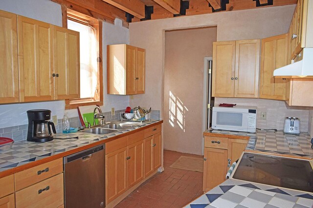 kitchen featuring sink, dishwasher, electric range oven, tile counters, and decorative backsplash