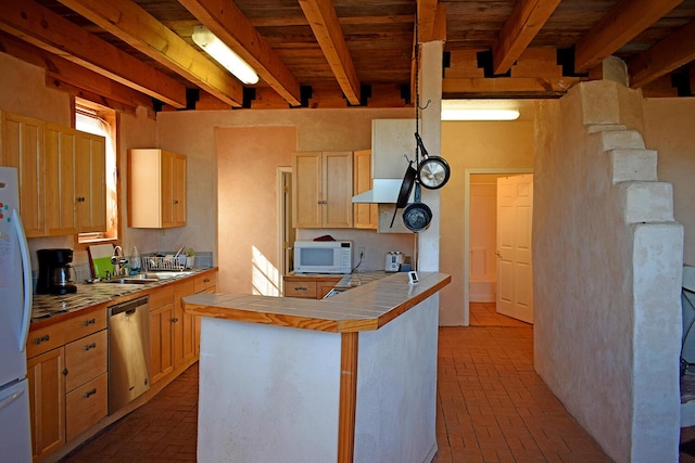 kitchen featuring white appliances, tile countertops, beamed ceiling, and light brown cabinets