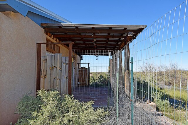 view of gate featuring an outbuilding