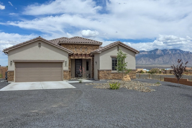 view of front of home featuring a garage and a mountain view