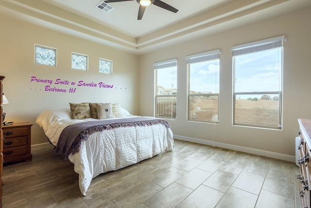 bedroom featuring multiple windows and ceiling fan