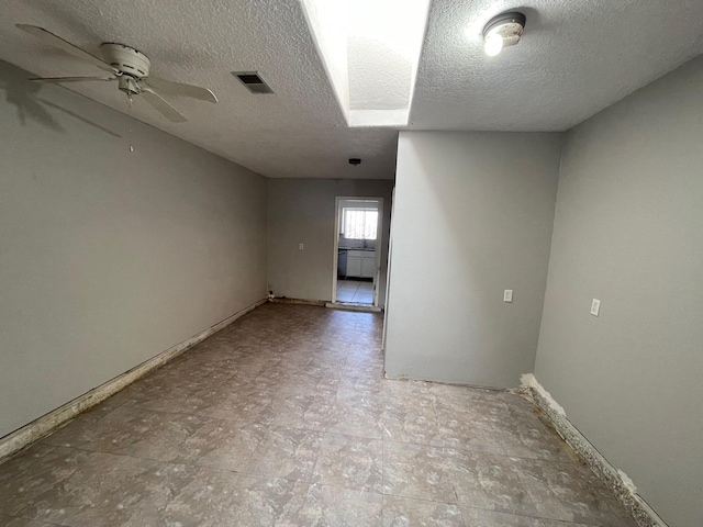 10613 Benavides Rd SW, Albuquerque, NM 87121 - spare room featuring a textured ceiling, ceiling fan, and baseboards
