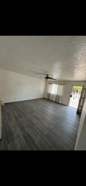 10613 Benavides Rd SW, Albuquerque, NM 87121 - spare room featuring dark wood-style floors and a textured ceiling