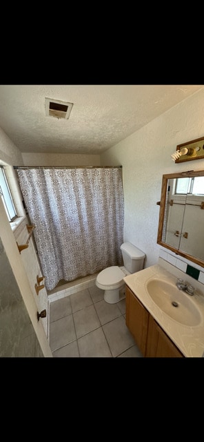 10613 Benavides Rd SW, Albuquerque, NM 87121 - bathroom featuring toilet, vanity, a textured ceiling, and tile patterned floors