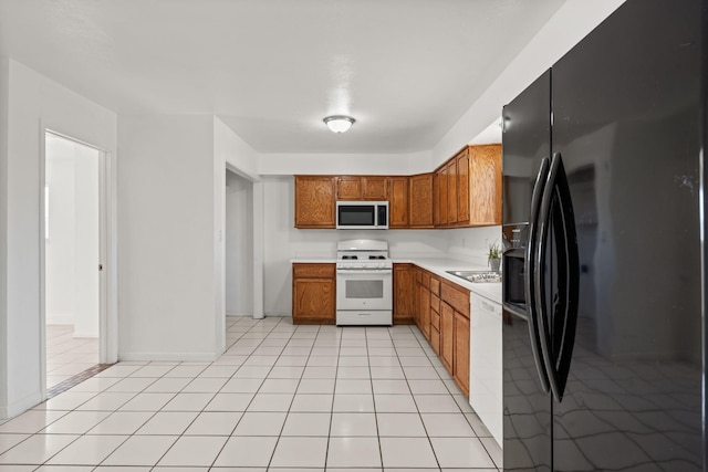 1613 Del Monte Trl SW, Albuquerque, NM 87121 - kitchen featuring light tile patterned flooring, white appliances, and sink