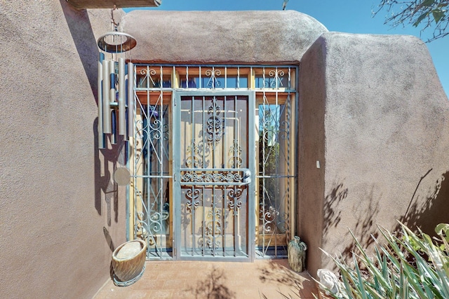 doorway to property with stucco siding