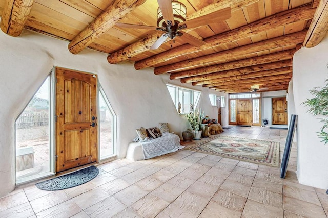 interior space with wooden ceiling, a ceiling fan, and beamed ceiling